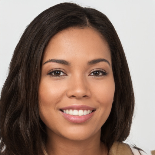 Joyful white young-adult female with long  brown hair and brown eyes