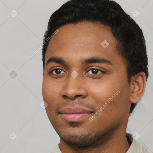 Joyful black young-adult male with short  black hair and brown eyes