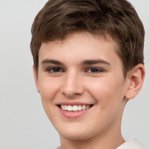 Joyful white child male with short  brown hair and brown eyes