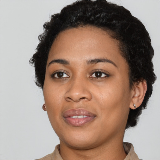 Joyful latino young-adult female with short  black hair and brown eyes