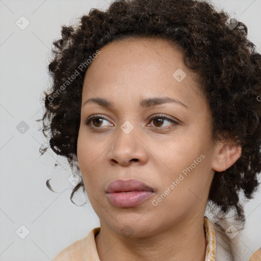 Joyful black young-adult female with medium  brown hair and brown eyes