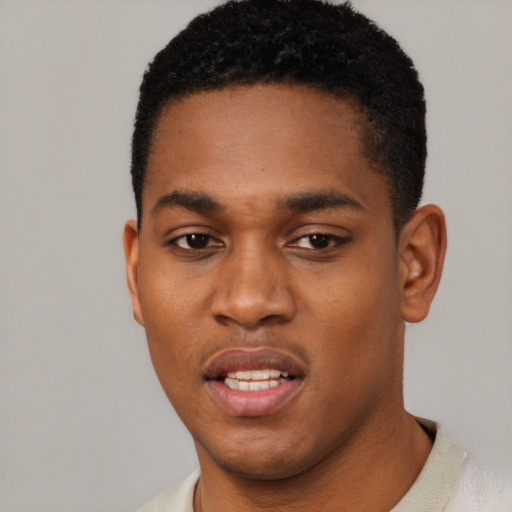 Joyful black young-adult male with short  black hair and brown eyes