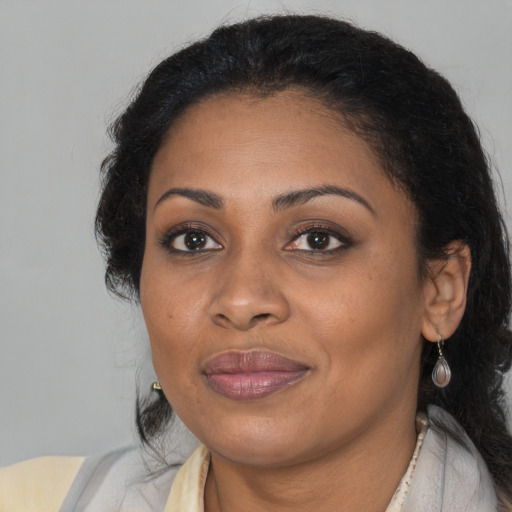 Joyful black adult female with medium  black hair and brown eyes