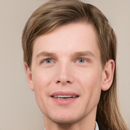 Joyful white young-adult male with short  brown hair and blue eyes