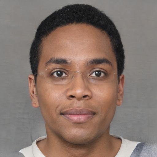 Joyful black young-adult male with short  brown hair and brown eyes