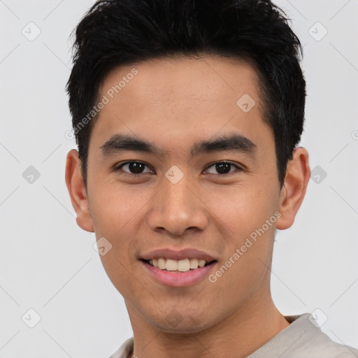 Joyful asian young-adult male with short  black hair and brown eyes