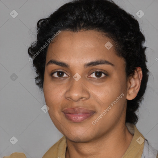 Joyful black young-adult female with long  black hair and brown eyes