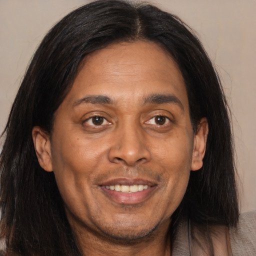 Joyful asian adult male with long  brown hair and brown eyes