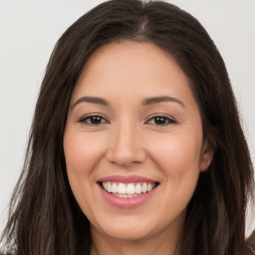 Joyful white young-adult female with long  brown hair and brown eyes