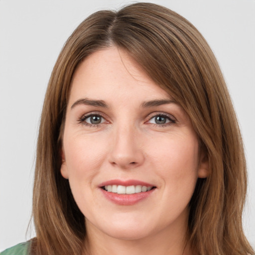 Joyful white young-adult female with medium  brown hair and green eyes