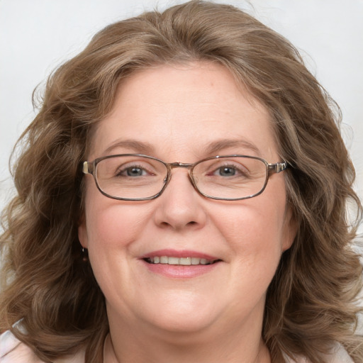 Joyful white adult female with medium  brown hair and blue eyes