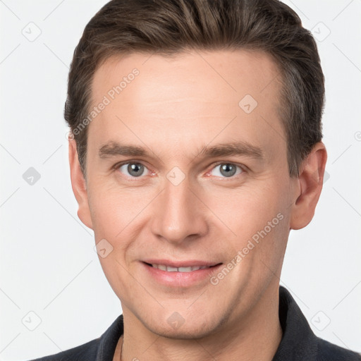 Joyful white young-adult male with short  brown hair and grey eyes