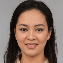 Joyful asian young-adult female with long  brown hair and brown eyes