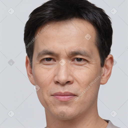 Joyful white adult male with short  black hair and brown eyes