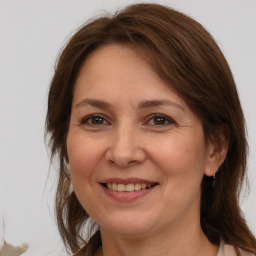 Joyful white adult female with medium  brown hair and brown eyes