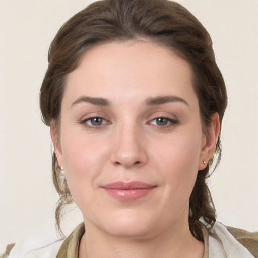 Joyful white young-adult female with medium  brown hair and grey eyes