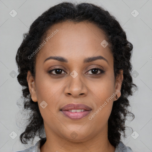Joyful black young-adult female with long  brown hair and brown eyes