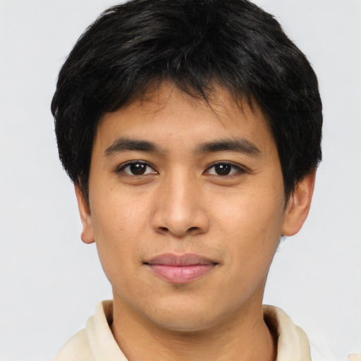 Joyful asian young-adult male with short  brown hair and brown eyes