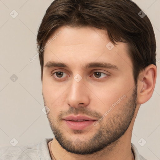 Joyful white young-adult male with short  brown hair and brown eyes