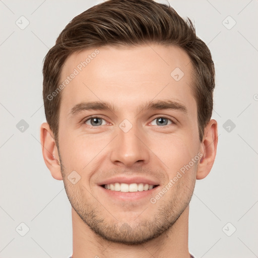 Joyful white young-adult male with short  brown hair and grey eyes