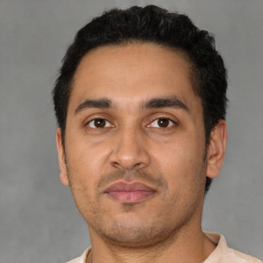 Neutral latino young-adult male with short  brown hair and brown eyes