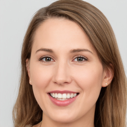 Joyful white young-adult female with long  brown hair and grey eyes