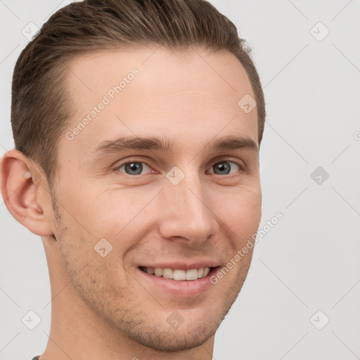 Joyful white young-adult male with short  brown hair and grey eyes