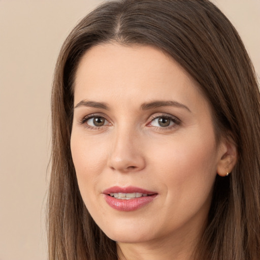 Joyful white young-adult female with long  brown hair and brown eyes