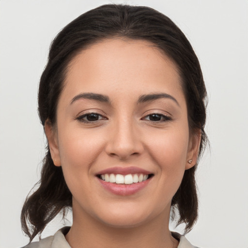 Joyful white young-adult female with medium  brown hair and brown eyes