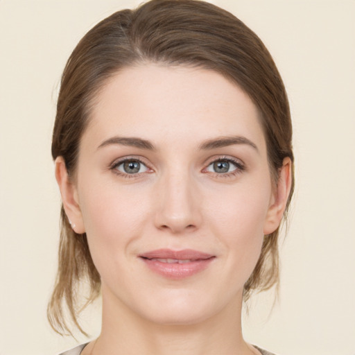 Joyful white young-adult female with medium  brown hair and grey eyes