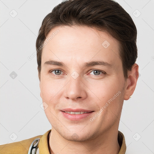 Joyful white young-adult male with short  brown hair and grey eyes