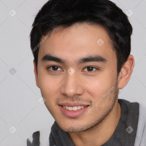 Joyful asian young-adult male with short  brown hair and brown eyes