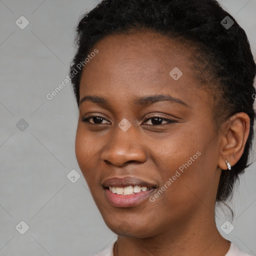 Joyful black young-adult female with short  black hair and brown eyes