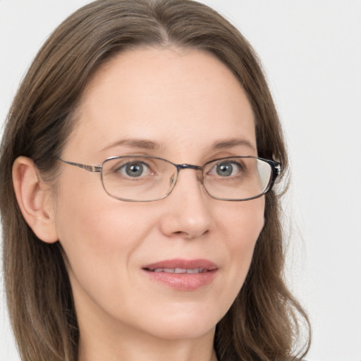 Joyful white adult female with long  brown hair and grey eyes