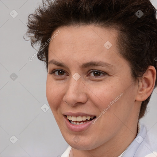 Joyful white adult female with short  brown hair and brown eyes