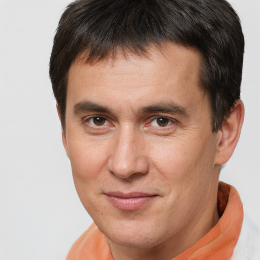 Joyful white adult male with short  brown hair and brown eyes