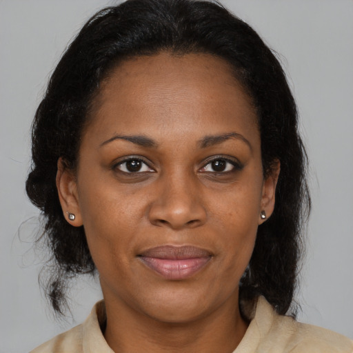 Joyful black adult female with medium  brown hair and brown eyes