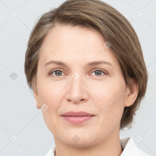 Joyful white adult female with medium  brown hair and grey eyes