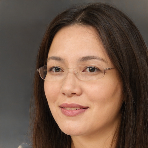 Joyful white adult female with long  brown hair and brown eyes
