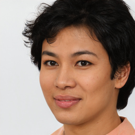 Joyful asian young-adult female with short  brown hair and brown eyes