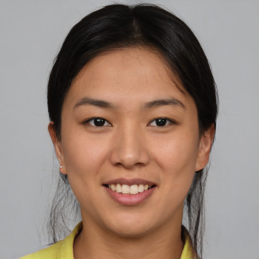 Joyful latino young-adult female with short  brown hair and brown eyes