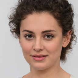 Joyful white young-adult female with medium  brown hair and green eyes