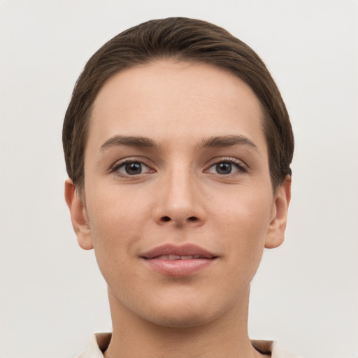 Joyful white young-adult female with short  brown hair and grey eyes