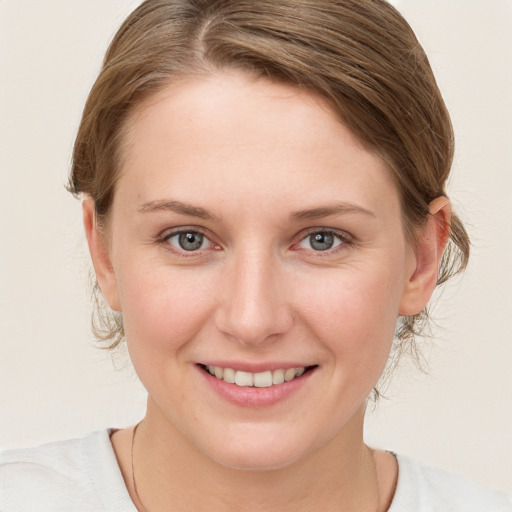 Joyful white young-adult female with medium  brown hair and blue eyes