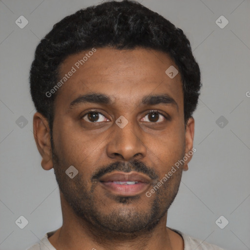 Joyful latino young-adult male with short  brown hair and brown eyes