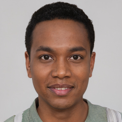 Joyful black young-adult male with short  black hair and brown eyes