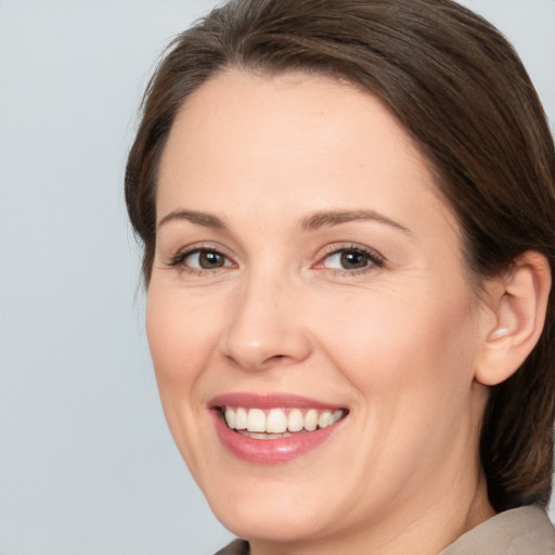 Joyful white adult female with medium  brown hair and brown eyes