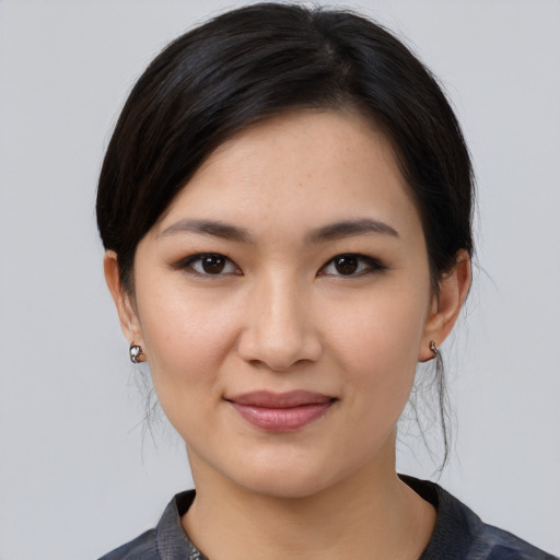 Joyful white young-adult female with medium  black hair and brown eyes