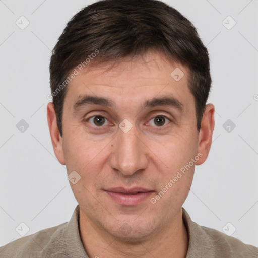 Joyful white adult male with short  brown hair and brown eyes