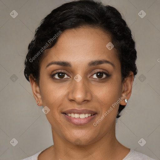 Joyful black young-adult female with short  brown hair and brown eyes